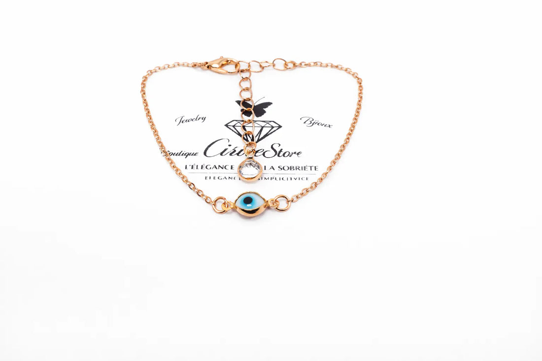 Bracelet doré avec motif œil bleu